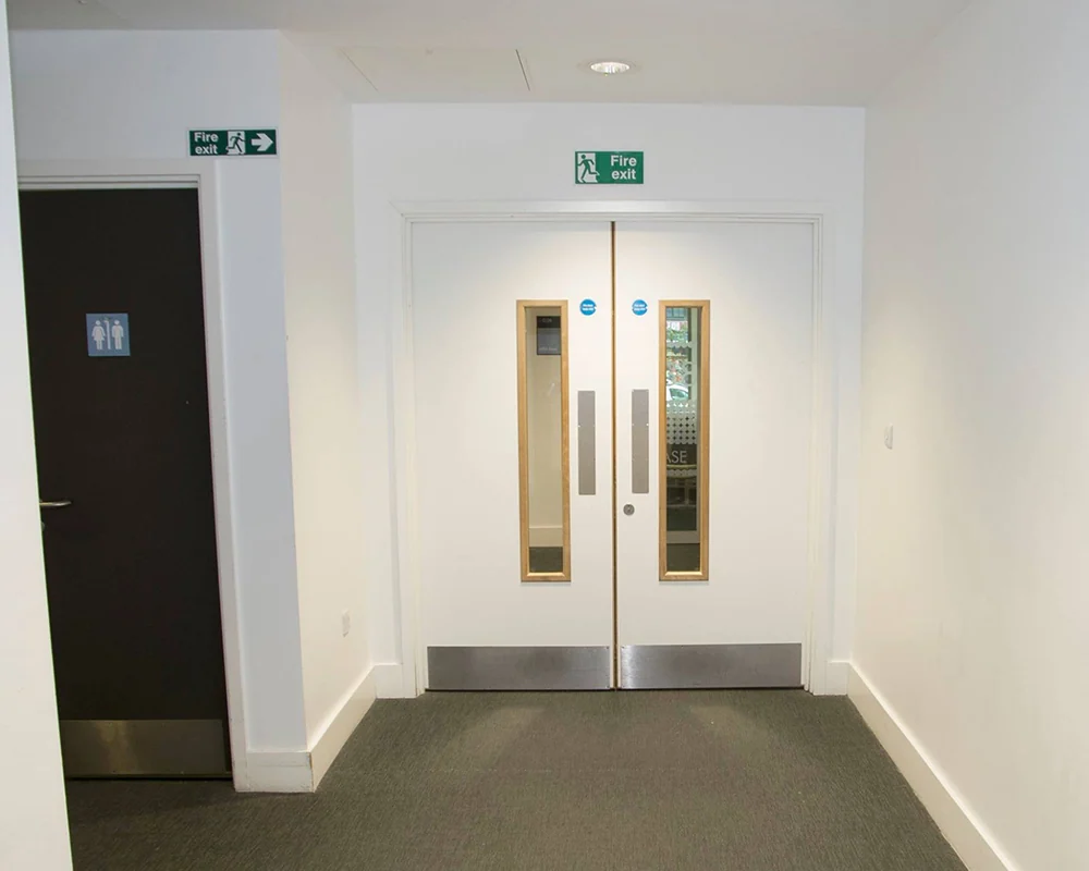 Installed white commercial double doors with vision panels