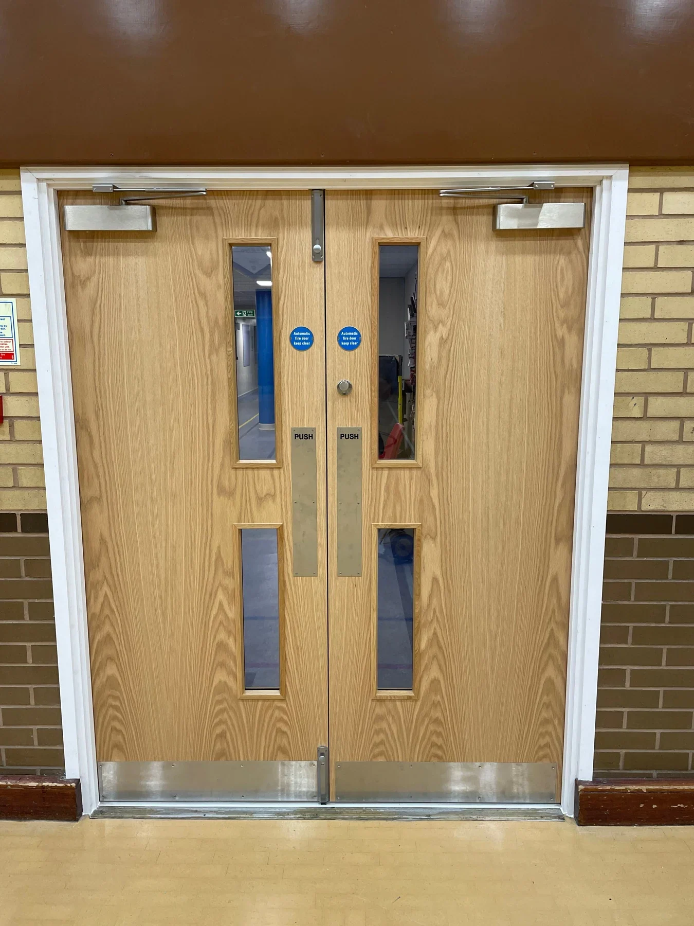 Installed timber-finish double doors with glazed panels