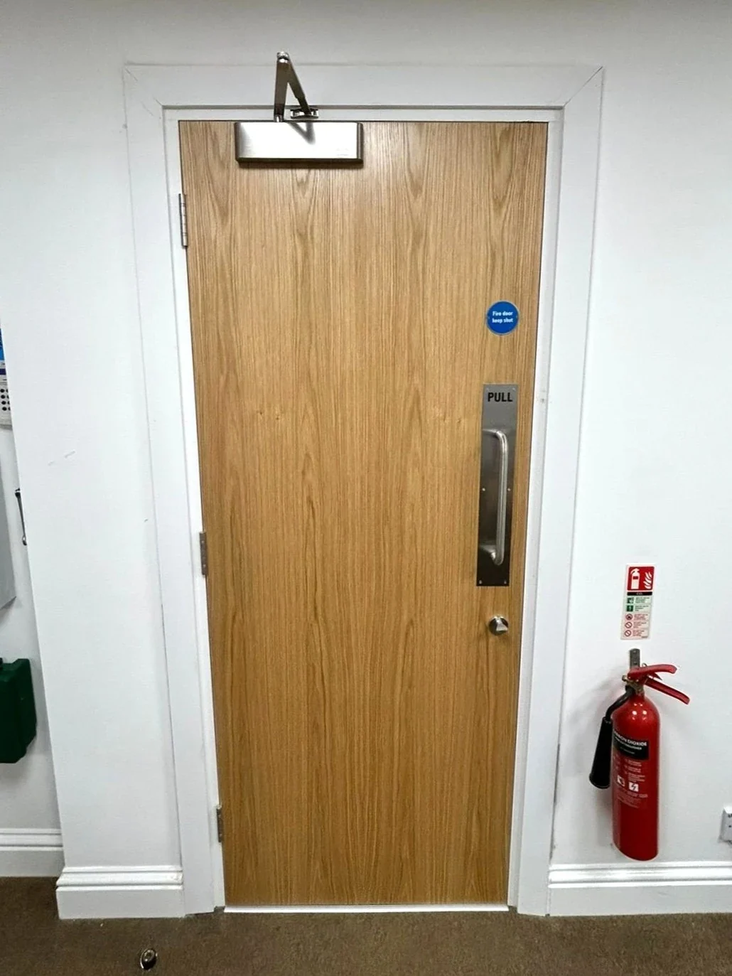 Oak veneer solid single door with an overhead closer