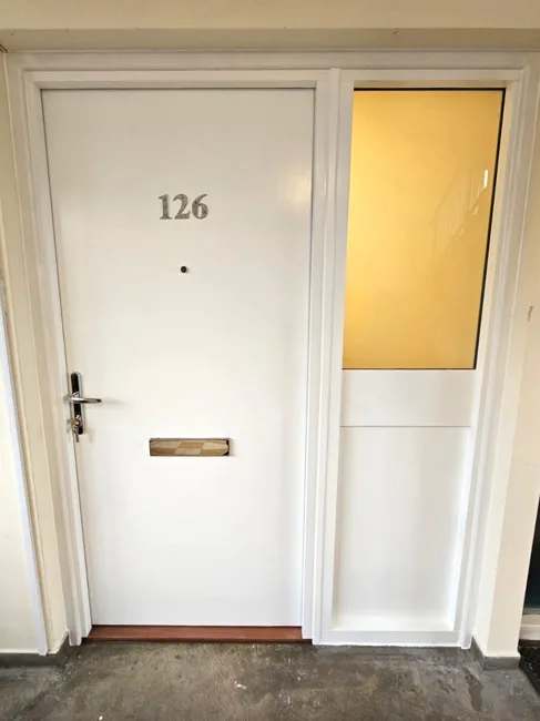 White residential entrance door with letterbox and glazed side panel
