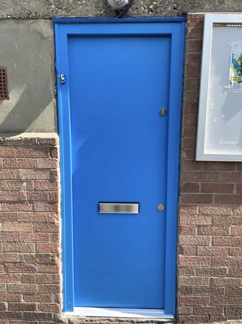 Blue residential entrance door with a letterbox
